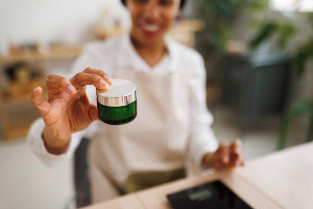 Woman holding jar with homemade organic skin moisturizer