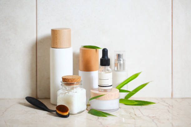 Face cream, serum, lotion, moisturizer and sea salt  among bamboo leaves in the bath